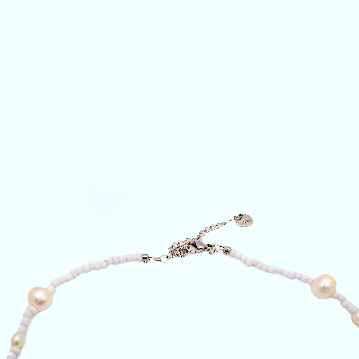 Close-up of adjustable stainless steel clasp with charm tag detail